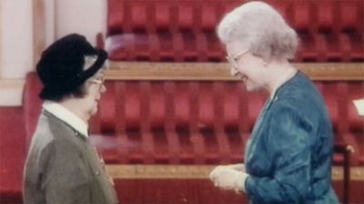 Elisabeth Beresford receiving her MBE from the Queen