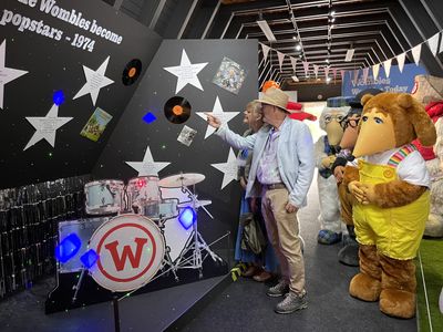 Marcus and Marianne looking at the exhibition, with the Wombles watching