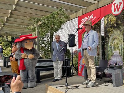 Marcus Robertson makes a speech, with Rupert Pugh and the Wombles watching